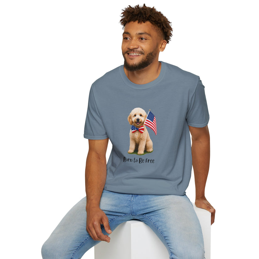 Male wearing T-shirt featuring a cute golden doodle puppy wearing an American flag bow tie and holding a small U.S. flag, with the phrase 'Born to Be Free' printed below the image.