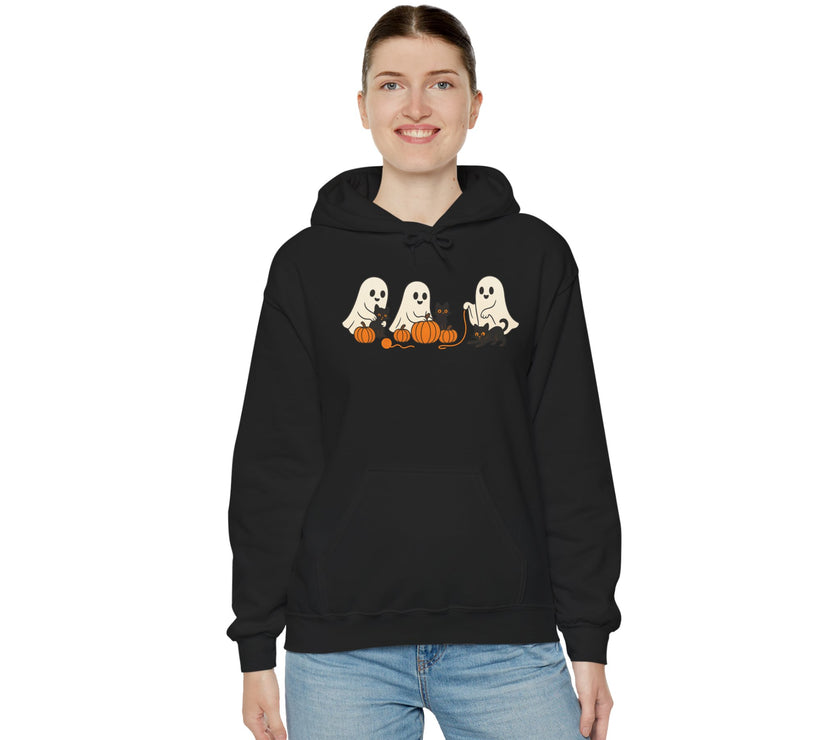 Person wearing a black hoodie with Halloween-themed design on a white background