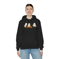 Person wearing a black hoodie with Halloween-themed design on a white background