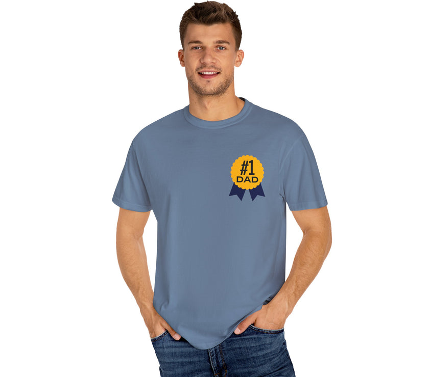 Jean color t-shirt featuring a yellow and navy blue award ribbon graphic on the chest with the text "#1 Dad," designed as a fun and heartfelt Father's Day gift.