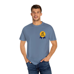 Jean color t-shirt featuring a yellow and navy blue award ribbon graphic on the chest with the text "#1 Dad," designed as a fun and heartfelt Father's Day gift.
