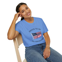 Smiling woman  wearing a white t-shirt with an American flag graphic and the words 'Proud to Be an American' printed around the flag