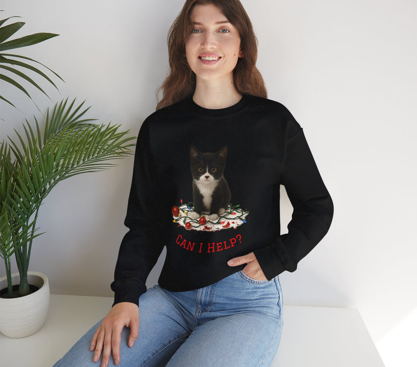 Woman wearing a black sweatshirt with a cat graphic and text, sitting on a white surface with a plant in the background.