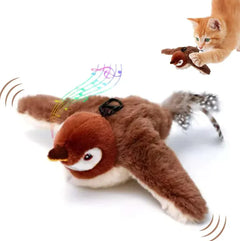 A playful orange kitten interacts with a plushbrown bird cat toy that features exaggerated eyes, sound and motion effects, and colorful musical notes to indicate interactive play.