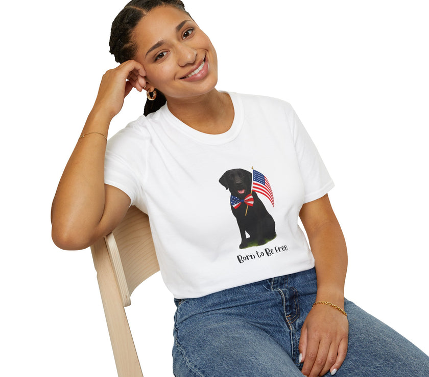 White t-shirt featuring a patriotic Black Lab wearing an American flag bowtie and holding U.S. flags, with the Black Labphrase "Born to Be Free" printed below — perfect for dog lovers and patriotic Americans.