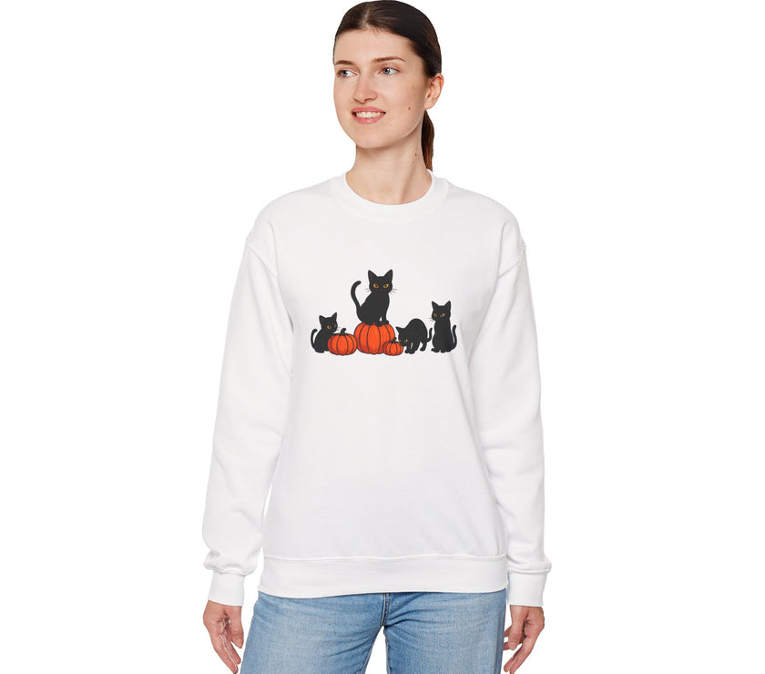 Woman wearing a white sweatshirt with black cat and orange pumpkin design on a white background