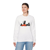 Woman wearing a white sweatshirt with black cat and orange pumpkin design on a white background
