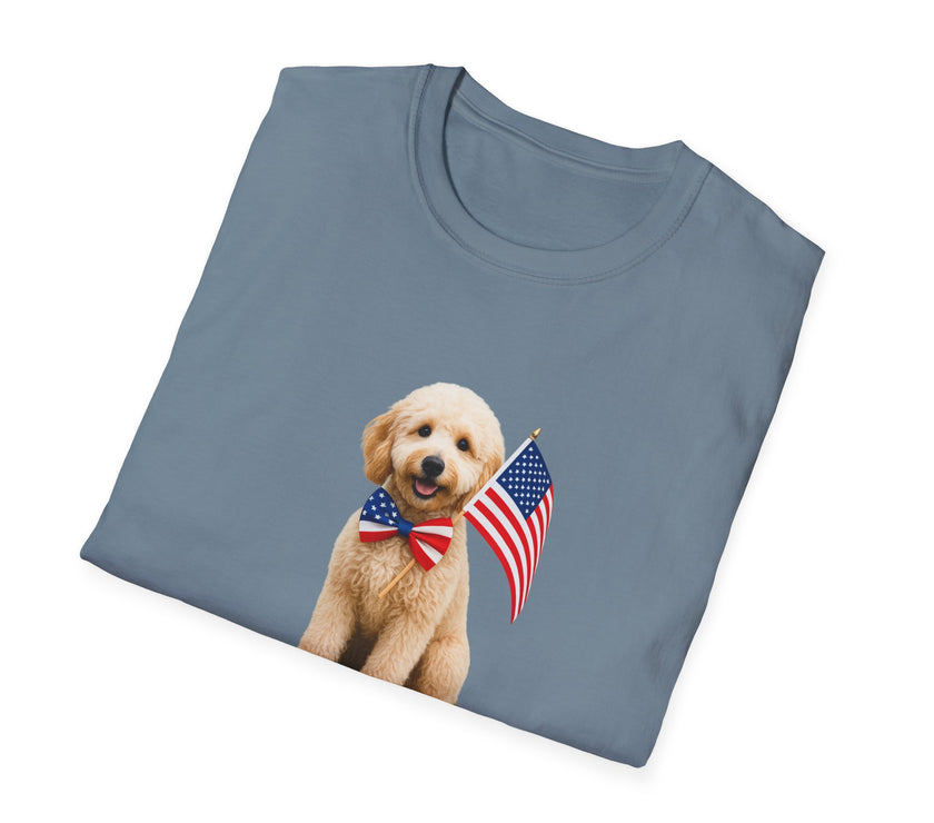 Folded T-shirt featuring a cute golden doodle puppy wearing an American flag bow tie and holding a small U.S. flag, with the phrase 'Born to Be Free' printed below the image.