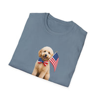 Folded T-shirt featuring a cute golden doodle puppy wearing an American flag bow tie and holding a small U.S. flag, with the phrase 'Born to Be Free' printed below the image.