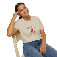 Person wearing a beige t-shirt with text and graphics, sitting on a chair.