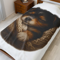 Blanket with Puppy wrapped in a knitted blanket on a white 