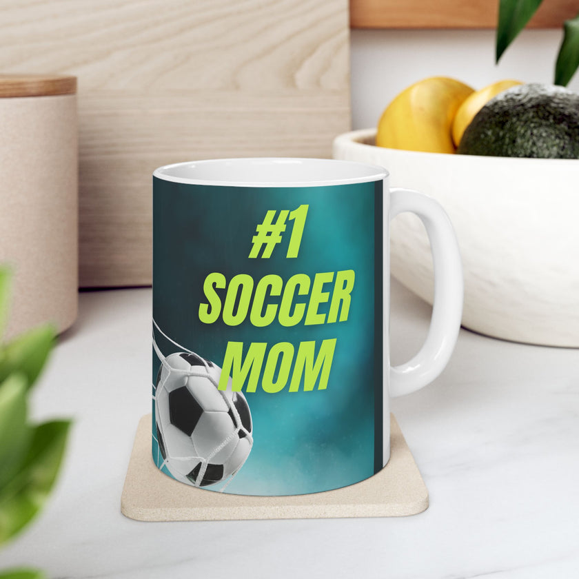 Mug with '#1 Soccer Mom' text and soccer ball design on a teal background