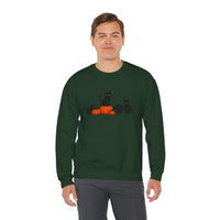 Man wearing a green sweatshirt with black cats and pumpkins design on a white background