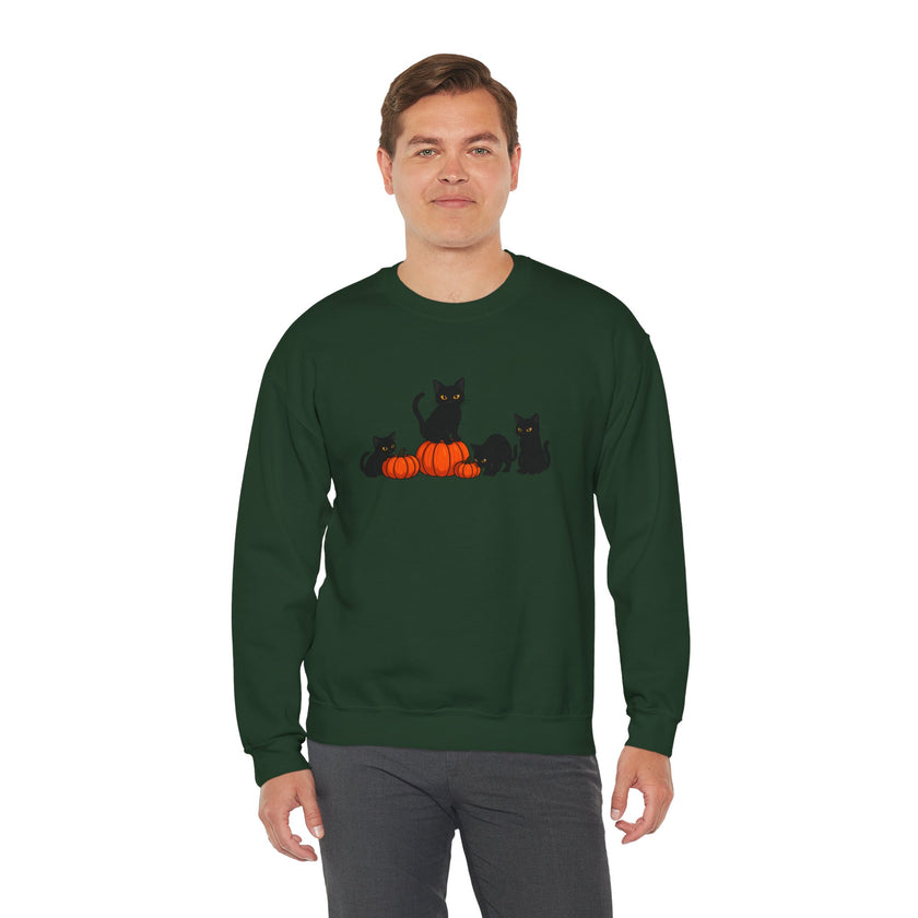 Man wearing a green sweatshirt with black cats and pumpkins design on a white background