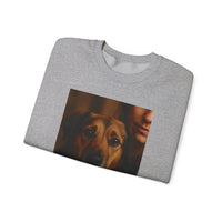 Folded gray sweatshirt with a printed design of a dog and a person on a white background