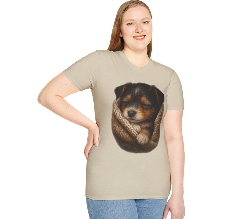 Woman wearing a beige t-shirt with a graphic of a dog in a knitted blanket on a white background