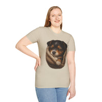Woman wearing a beige t-shirt with a graphic of a dog in a knitted blanket on a white background