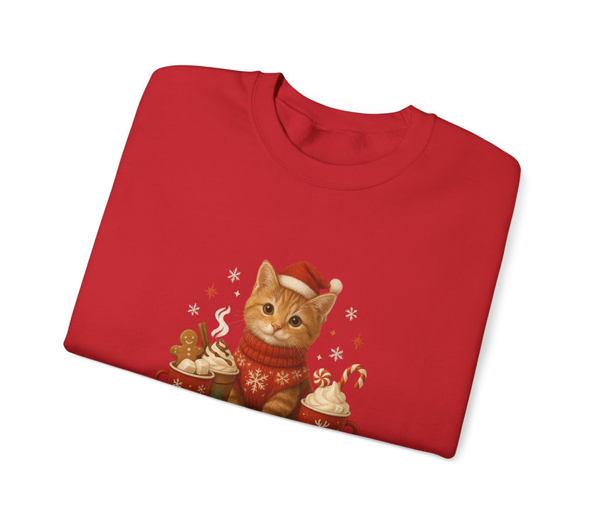 Folded red sweater with a Christmas-themed cat design on a white background