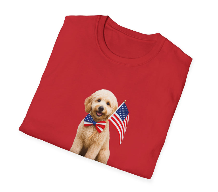 Folded T-shirt featuring a cute golden doodle puppy wearing an American flag bow tie and holding a small U.S. flag, with the phrase 'Born to Be Free' printed below the image.