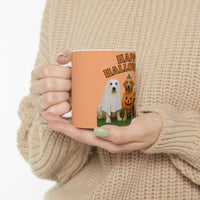 Person holding a mug with Halloween design featuring two dogs in costumes on a white background