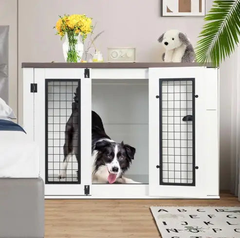 White pet crate with black grid doors in a room with a dog inside, a vase of yellow flowers, and a stuffed animal.