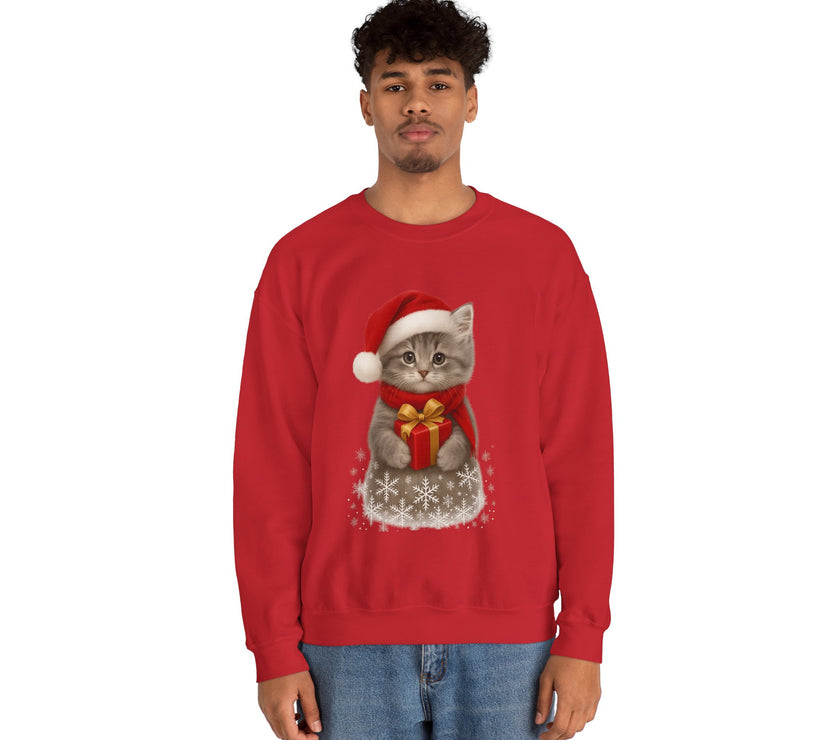 Red sweatshirt featuring a gray kitten wearing a Santa hat and red scarf, holding a small red gift box with a gold bow, surrounded by snowflake designs.