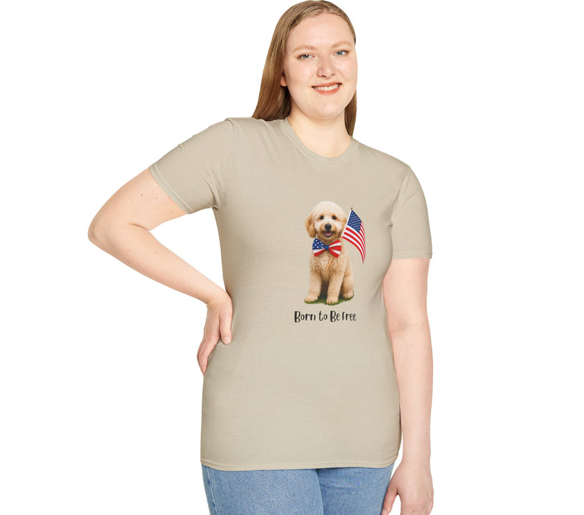 Female wearing T-shirt featuring a cute golden doodle puppy wearing an American flag bow tie and holding a small U.S. flag, with the phrase 'Born to Be Free' printed below the image.