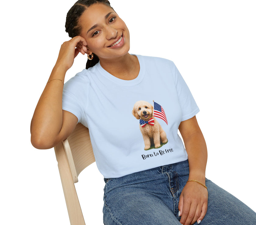 Female wearing T-shirt featuring a cute golden doodle puppy wearing an American flag bow tie and holding a small U.S. flag, with the phrase 'Born to Be Free' printed below the image.