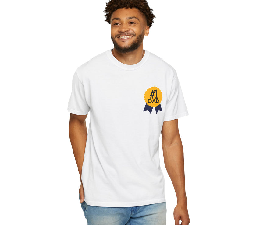 White t-shirt featuring a yellow and navy blue award ribbon graphic on the chest with the text "#1 Dad," designed as a fun and heartfelt Father's Day gift.