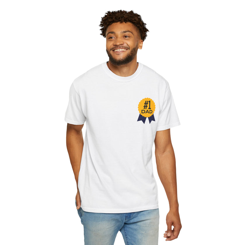 White t-shirt featuring a yellow and navy blue award ribbon graphic on the chest with the text "#1 Dad," designed as a fun and heartfelt Father's Day gift.