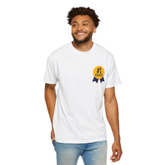 White t-shirt featuring a yellow and navy blue award ribbon graphic on the chest with the text "#1 Dad," designed as a fun and heartfelt Father's Day gift.