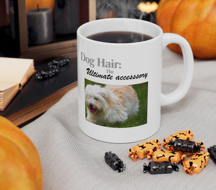 White ceramic mug featuring a photo of dogs lying on grass, with the humorous quote "Dog Hair: The Ultimate Accessory" printed below the image.
