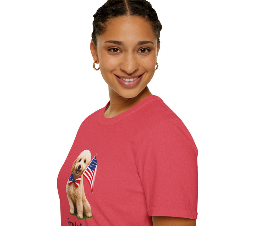 Female wearing T-shirt featuring a cute golden doodle puppy wearing an American flag bow tie and holding a small U.S. flag, with the phrase 'Born to Be Free' printed below the image.