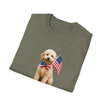 Folded T-shirt featuring a cute golden doodle puppy wearing an American flag bow tie and holding a small U.S. flag, with the phrase 'Born to Be Free' printed below the image.