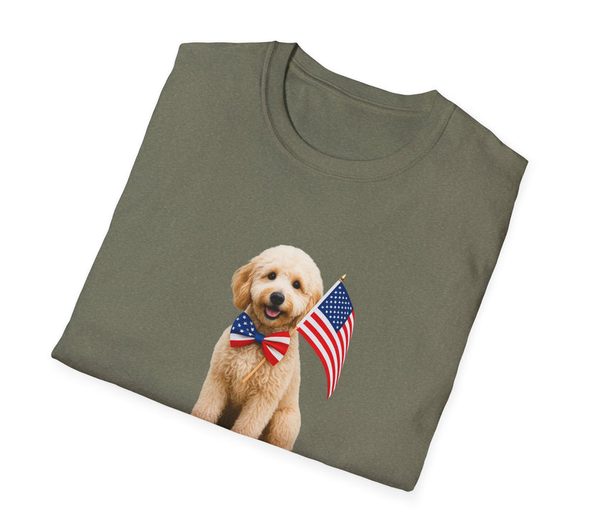 Folded T-shirt featuring a cute golden doodle puppy wearing an American flag bow tie and holding a small U.S. flag, with the phrase 'Born to Be Free' printed below the image.