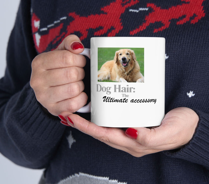 White ceramic mug featuring a photo of a smiling golden retriever lying on grass, with the humorous quote "Dog Hair: The Ultimate Accessory" printed below the image.
