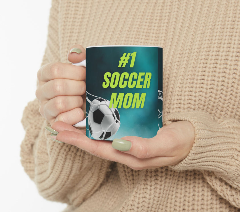 Mug with '#1 Soccer Mom' text and soccer ball design on a teal background