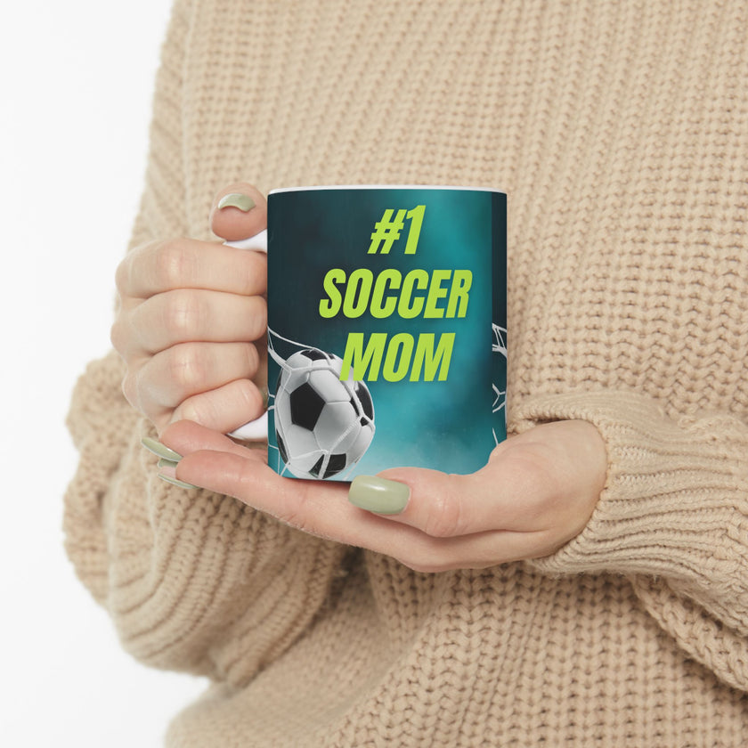 Mug with '#1 Soccer Mom' text and soccer ball design on a teal background