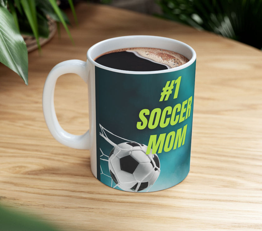 Mug with '#1 Soccer Mom' text and soccer ball design on a teal background