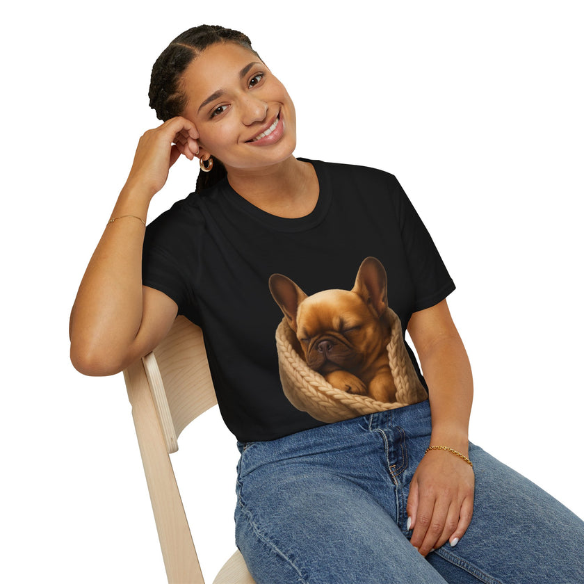 Person wearing a black t-shirt with a dog graphic, sitting on a chair.