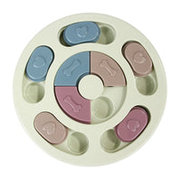 a pastel-colored round-shaped puzzle toy - uncover kibble stored beneath the sliders.