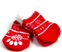 Red pet mittens with white paw prints on a white background