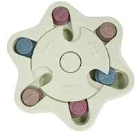 a pastel-colored  puzzle toy - uncover kibble stored beneath the sliders.