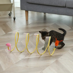 Cat playing with a toy on a wooden floor in a living room.
