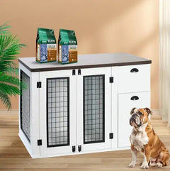 Dog kennel with two bags of dog food on a table, with a dog sitting in front.
