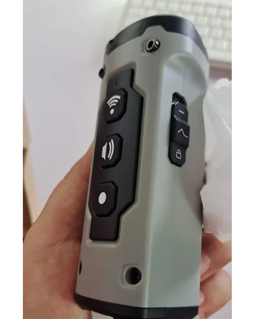 A close-up view of a black handheld ultrasonic dog training device featuring three mesh speaker emitters, control buttons, and an integrated flashlight on top.