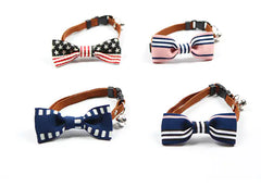 Four dog collars with bow ties in different designs on a white background