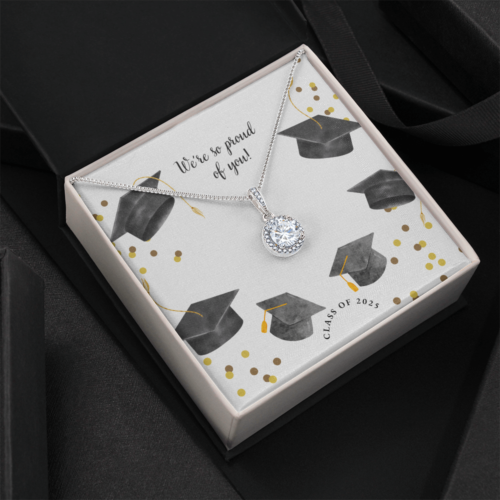 Open gift box displaying a sparkling silver Eternal Hope necklace with a round pendant, set against a graduation-themed message card that reads "We're so proud of you!" with graduation caps, gold confetti, and "Class of 2025" text.