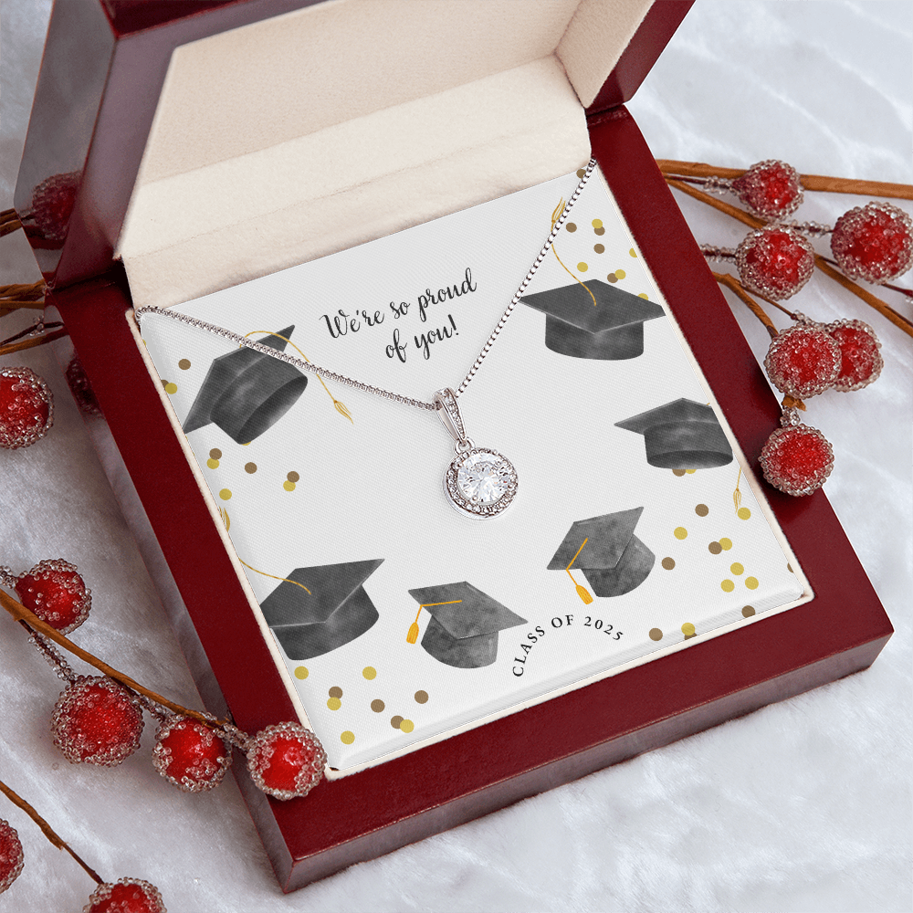 Open gift box displaying a sparkling silver Eternal Hope necklace with a round pendant, set against a graduation-themed message card that reads "We're so proud of you!" with graduation caps, gold confetti, and "Class of 2025" text.