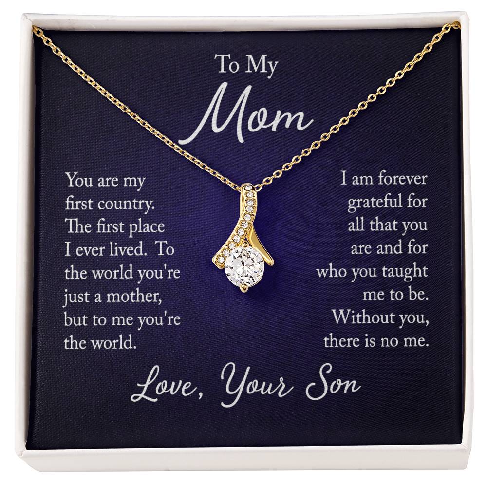 Alluring Beauty necklace features a petite ribbon shaped pendant with message card To Mom